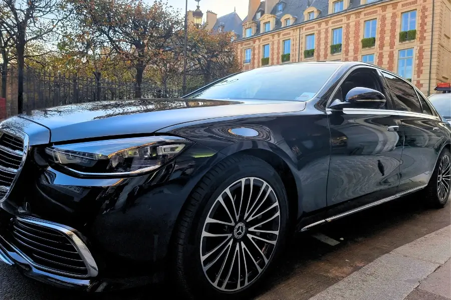 Luxury black Mercedes S-Class parked in front of a classic building, chauffeured service by CTP Limo.