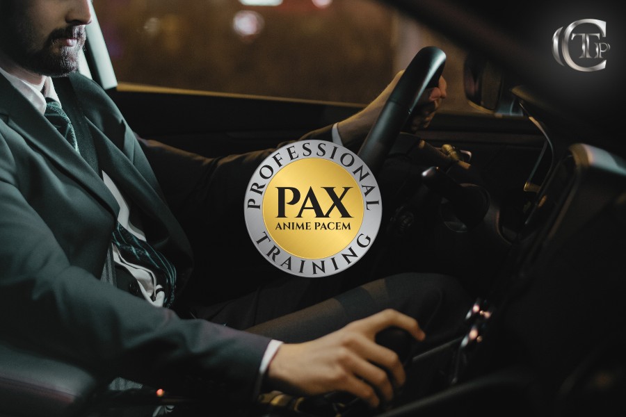 Professional chauffeur driving a luxury vehicle, highlighting advanced training and certified standards by PAX Training.